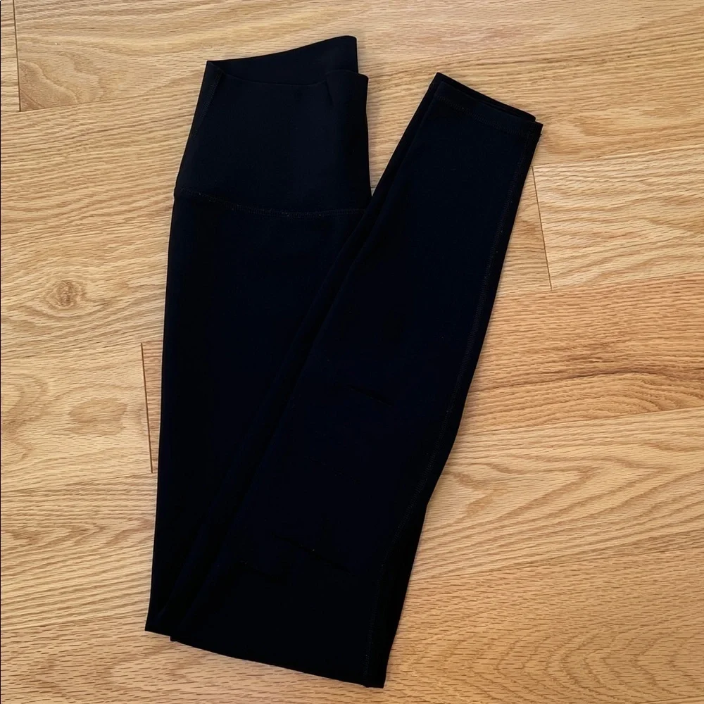 ALO Yoga black ripped high waist warrior leggings.